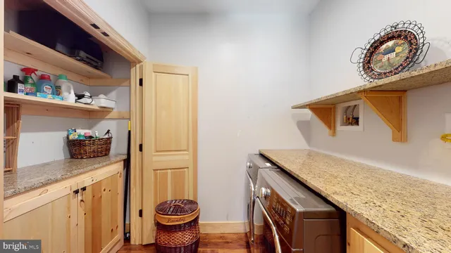 a living room with furniture a air conditioner and a flat screen tv