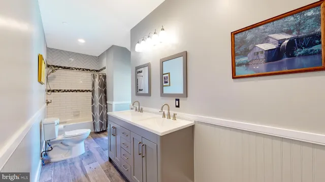 a view of a livingroom with wooden floor and a ceiling fan
