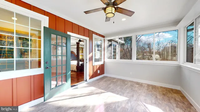 a living room with furniture a floor to ceiling window and a flat screen tv