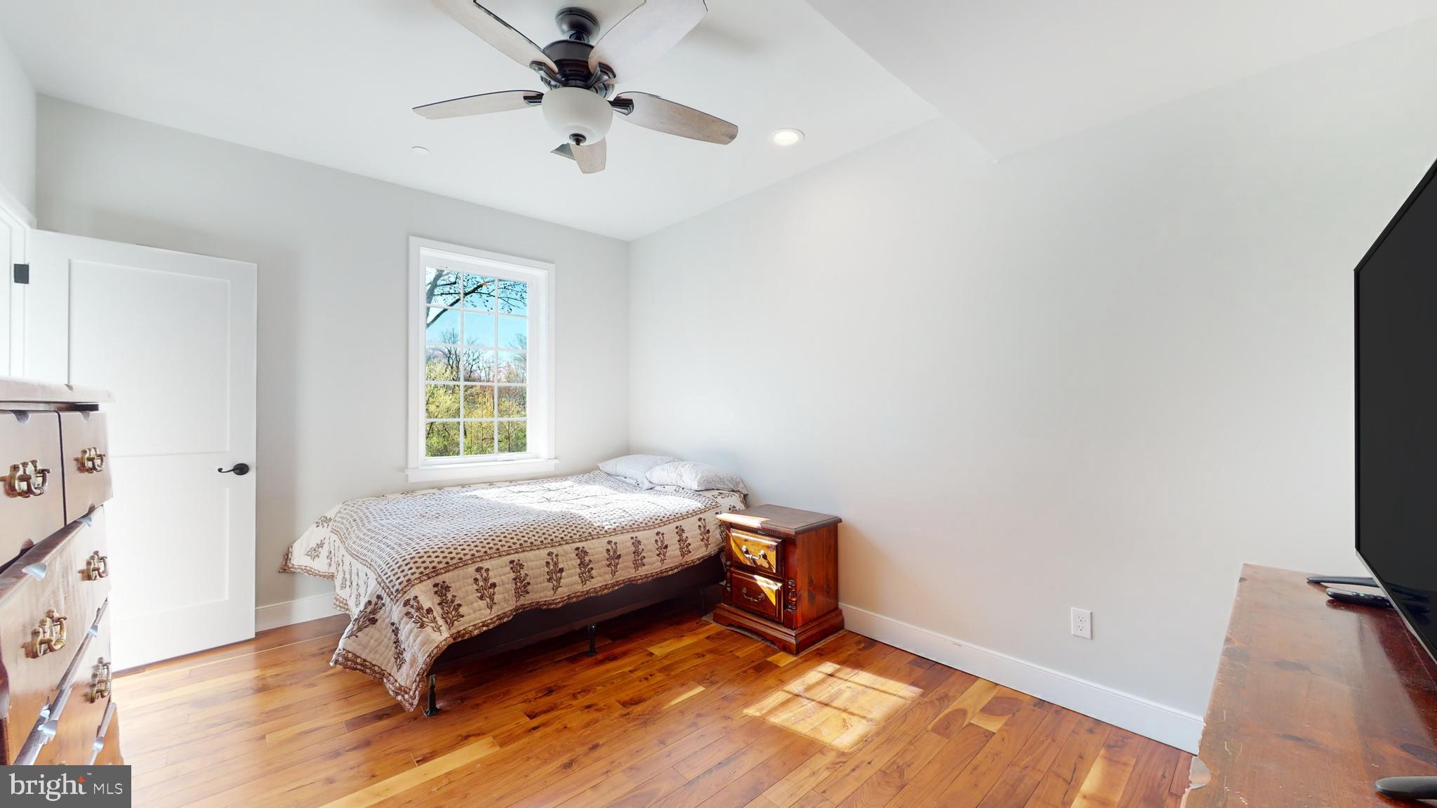 901 Crum Creek Road Springfield, PA 19064 - Photo 47 of 116 a bedroom with a bed and a flat tv screen on the dresser