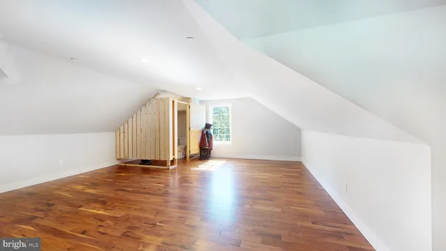 a view of a house with a small yard and large tree