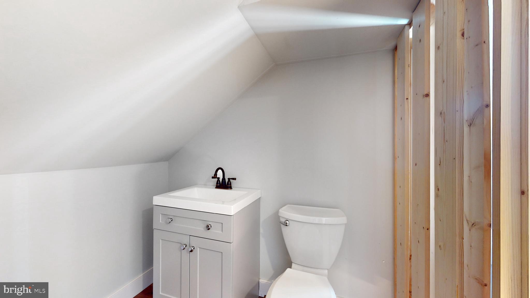 901 Crum Creek Road Springfield, PA 19064 - Photo 51 of 116 a bathroom with a toilet sink and mirror