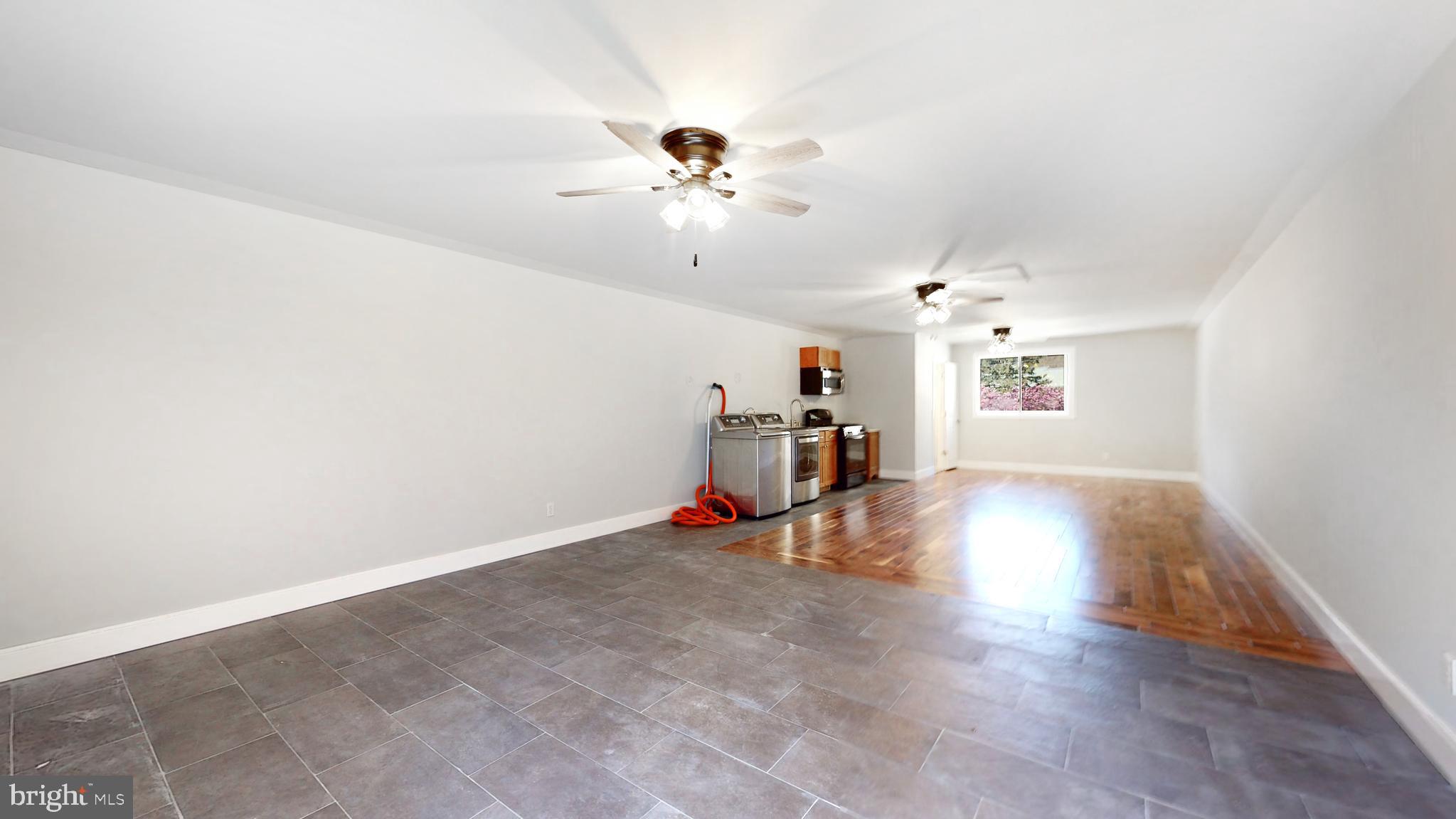 901 Crum Creek Road Springfield, PA 19064 - Photo 61 of 116 a view of a livingroom with wooden floor and a ceiling fan