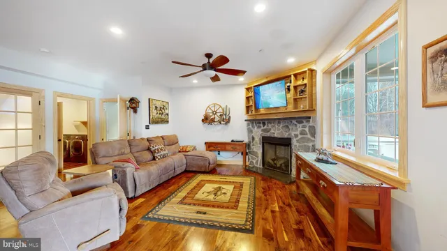 a bedroom with furniture and a wooden floor