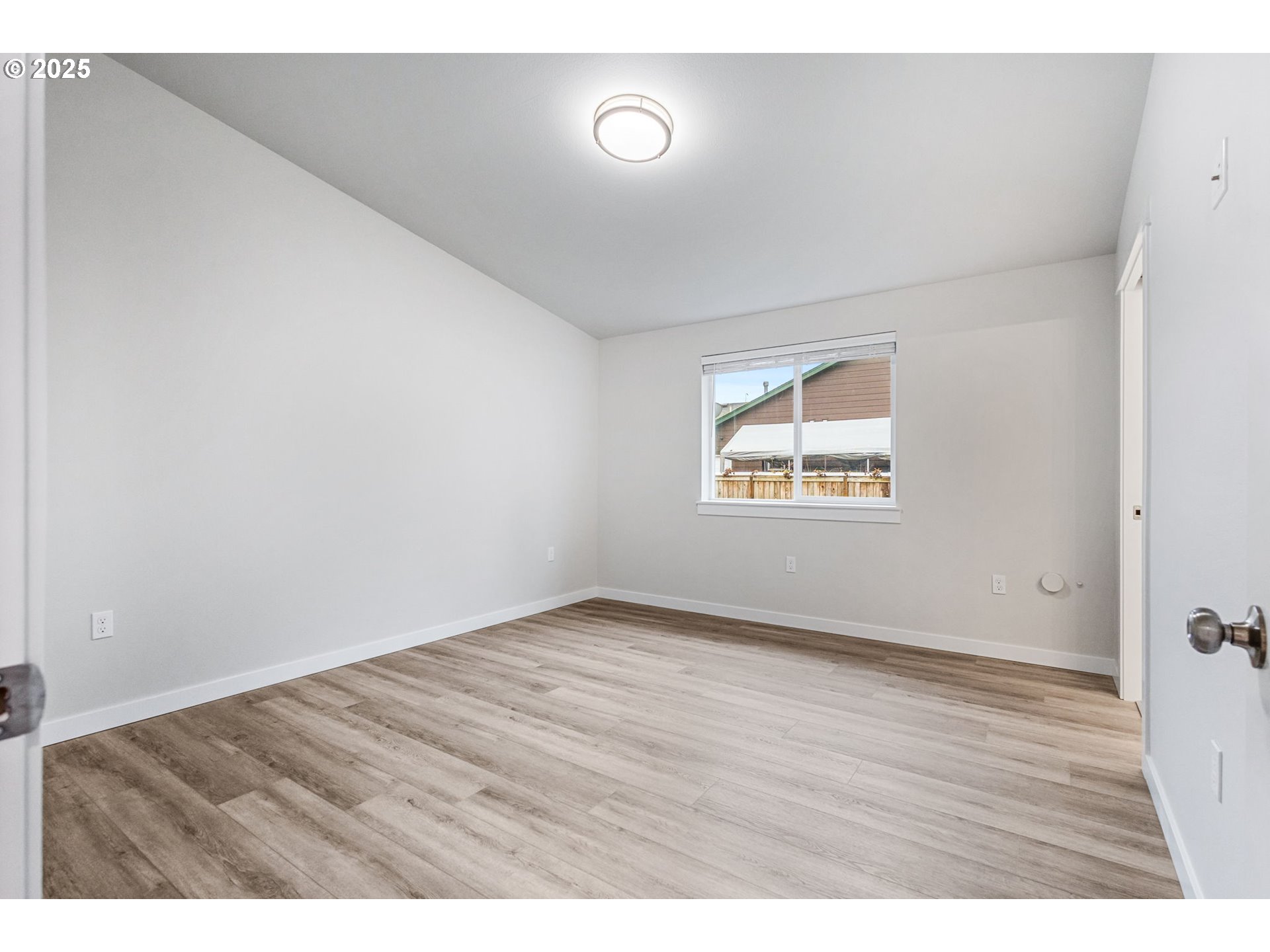 3627 Green River Road Sweet Home, OR 97386 - Photo 4 of 32 a view of an empty room with wooden floor and a window