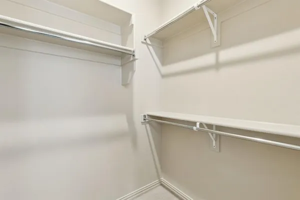 a bathroom with a double vanity sink a toilet and shower