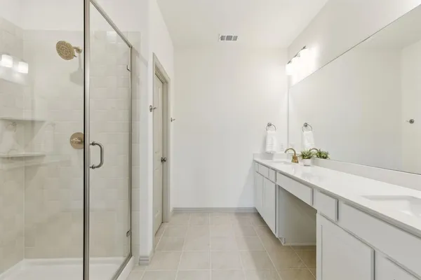 a bathroom with a glass shower door