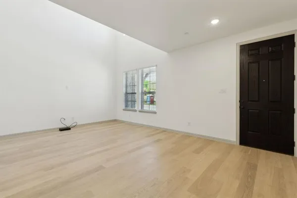 a kitchen with a sink a stove a refrigerator and white cabinets