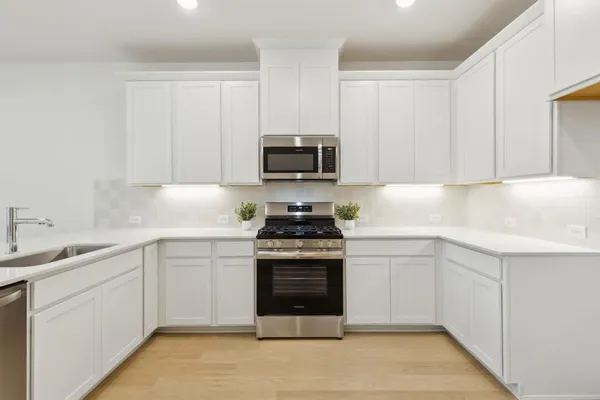 a kitchen with a sink cabinets and stainless steel appliances