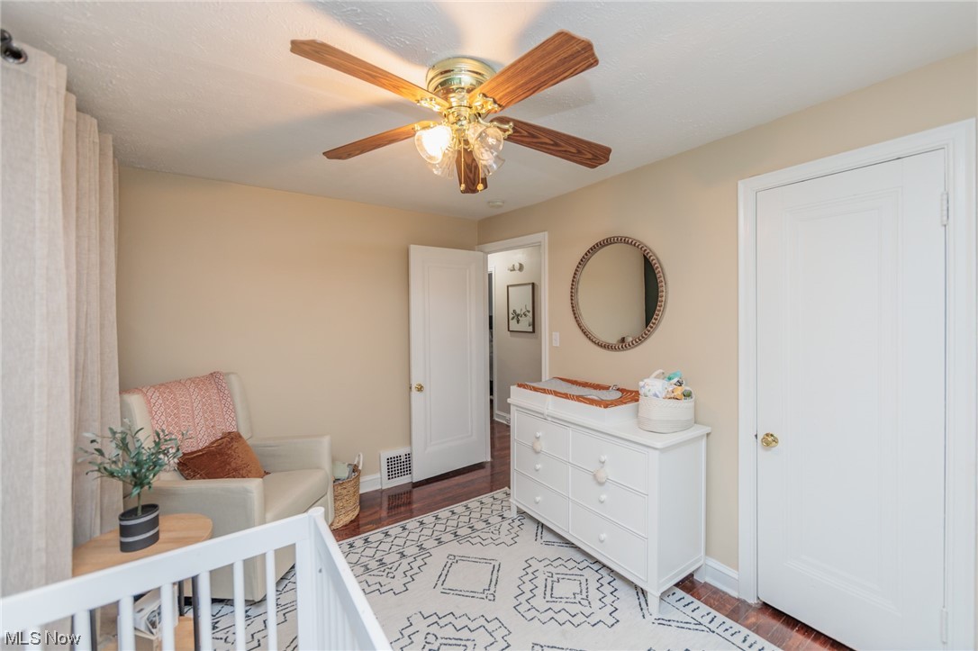 2199 Cranston Road Cleveland, OH 44118 - Photo 25 of 40 Bedroom with a crib, light wood-type flooring, and ceiling fan