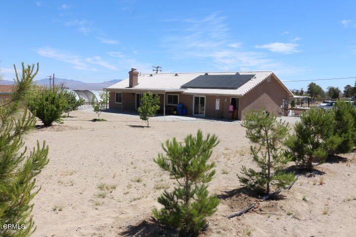 9522 Mesa Road Lucerne Valley, CA 92356 - Photo 2 of 3 a front view of a house with a yard