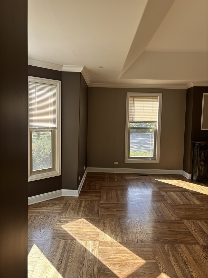 40 Mischa Court, Unit 100 Lake Zurich, IL 60047 - Photo 14 of 36 an empty room with wooden floor and windows
