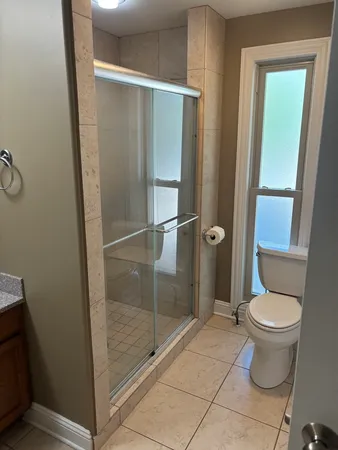 a view of room with window and a ceiling fan