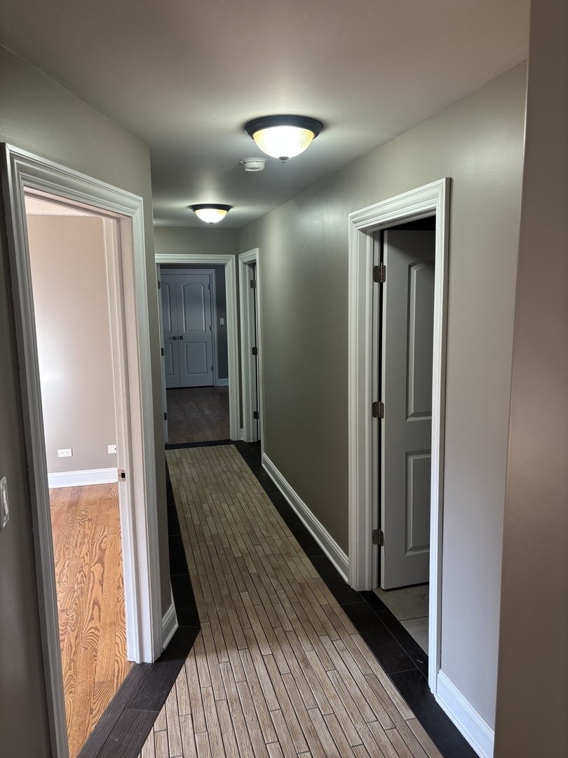 40 Mischa Court, Unit 100 Lake Zurich, IL 60047 - Photo 21 of 36 a view of hallway with wooden floor