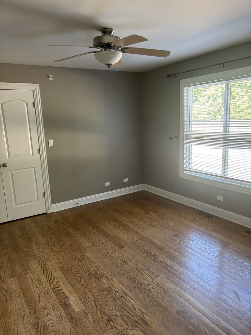 40 Mischa Court, Unit 100 Lake Zurich, IL 60047 - Photo 26 of 36 an empty room with wooden floor fan and windows