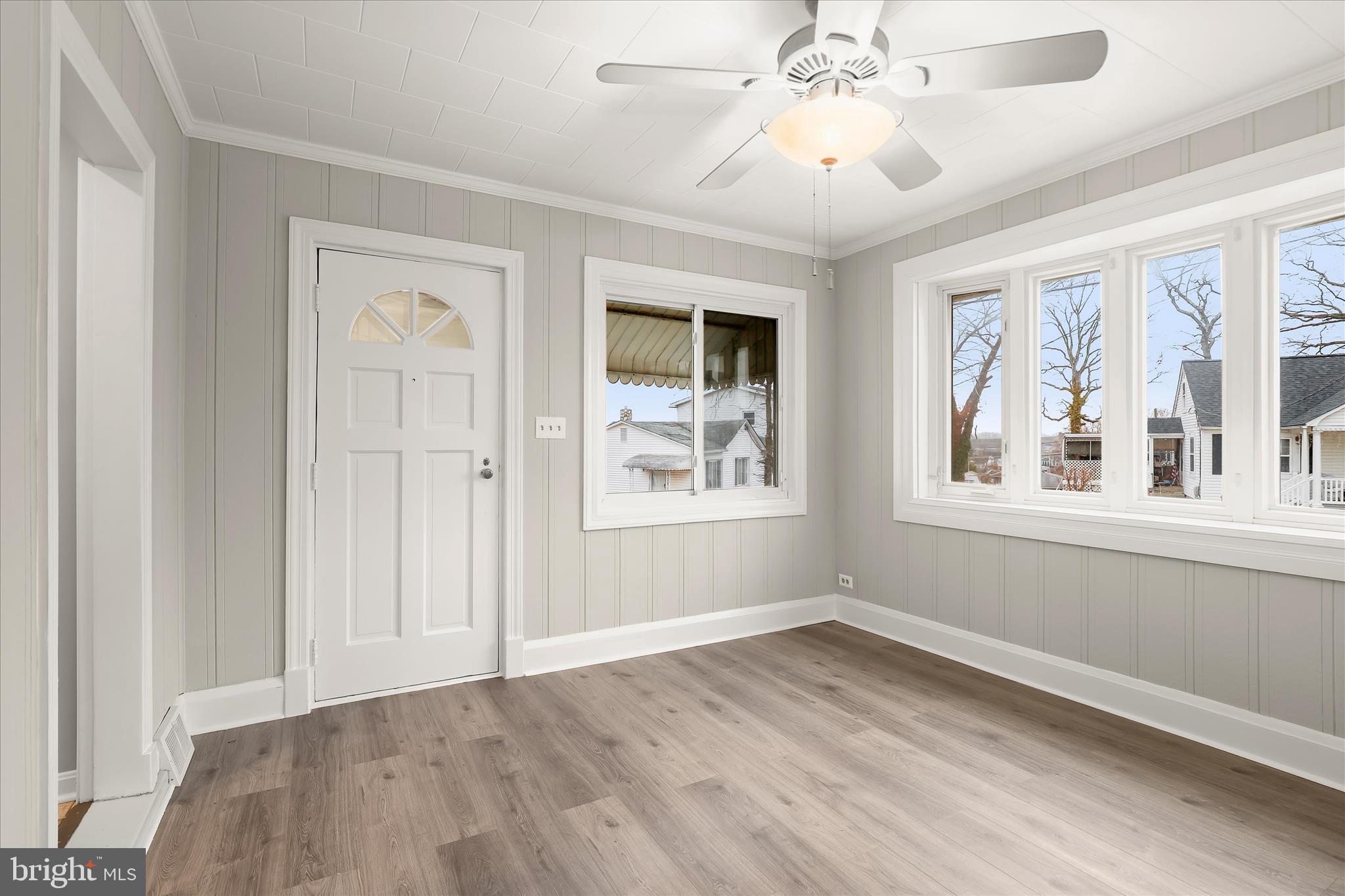 1218 Rustic Avenue Rosedale, MD 21237 - Photo 4 of 34 a view of an empty room with a window and wooden floor