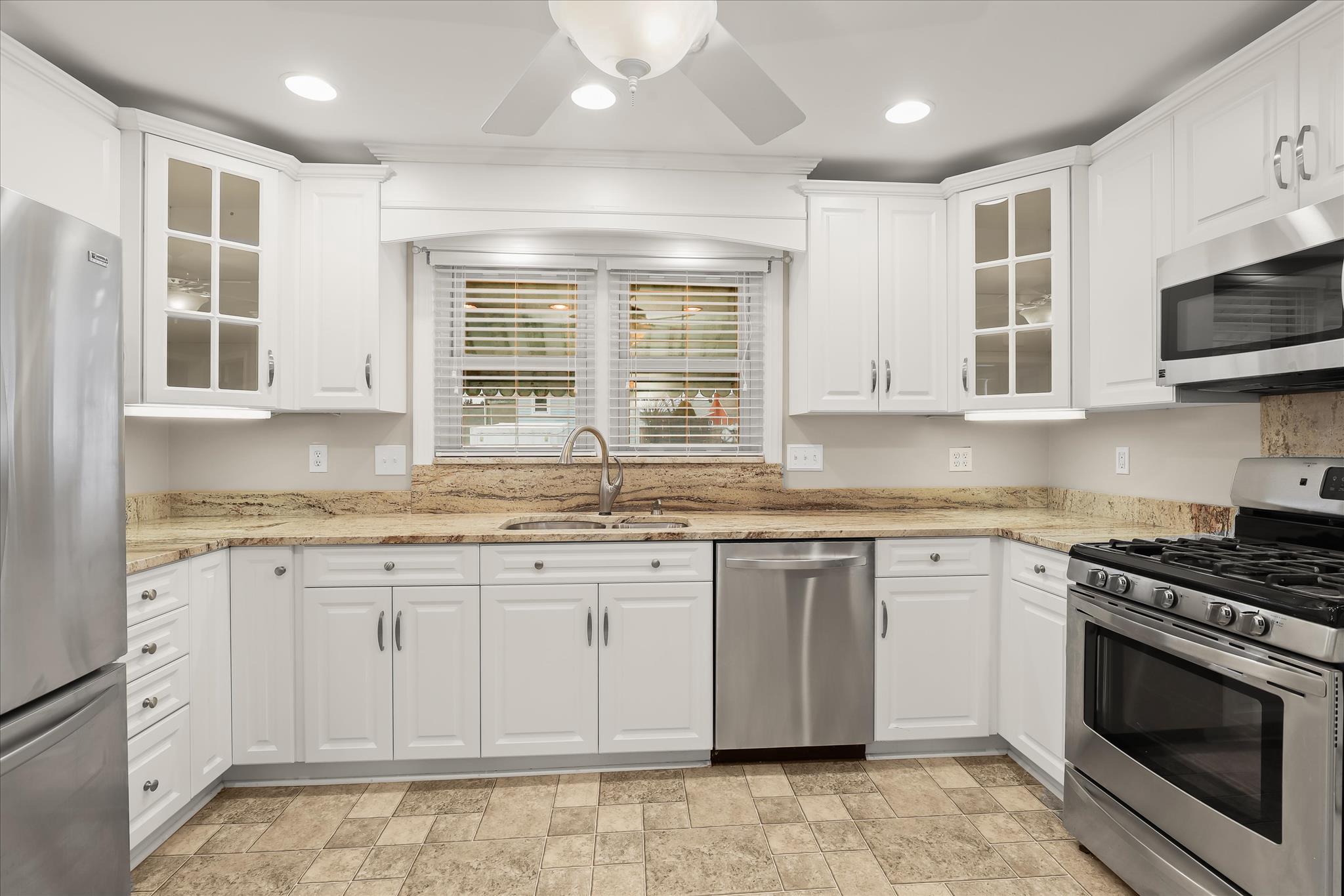 1218 Rustic Avenue Rosedale, MD 21237 - Photo 9 of 34 a kitchen with stainless steel appliances granite countertop a stove a sink and a microwave