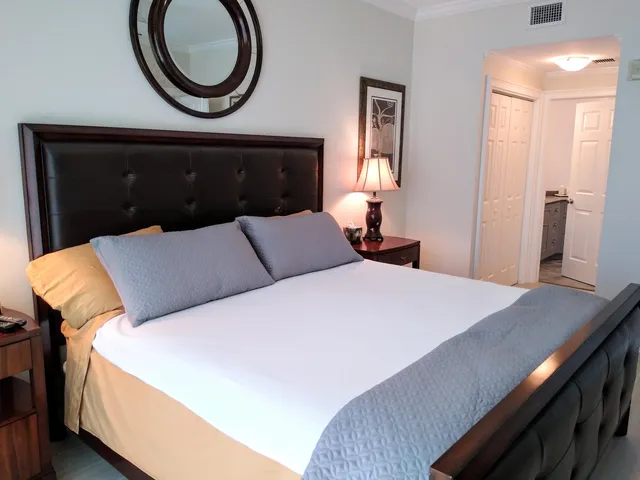 a bedroom with a bed and a mirror