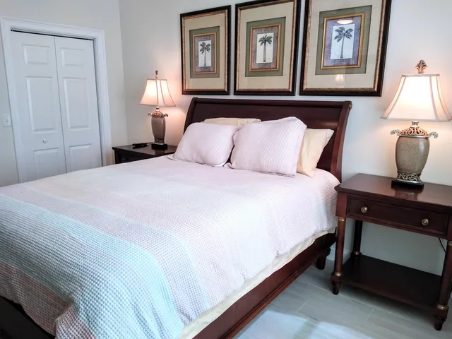 a bedroom with a bed and a lamp