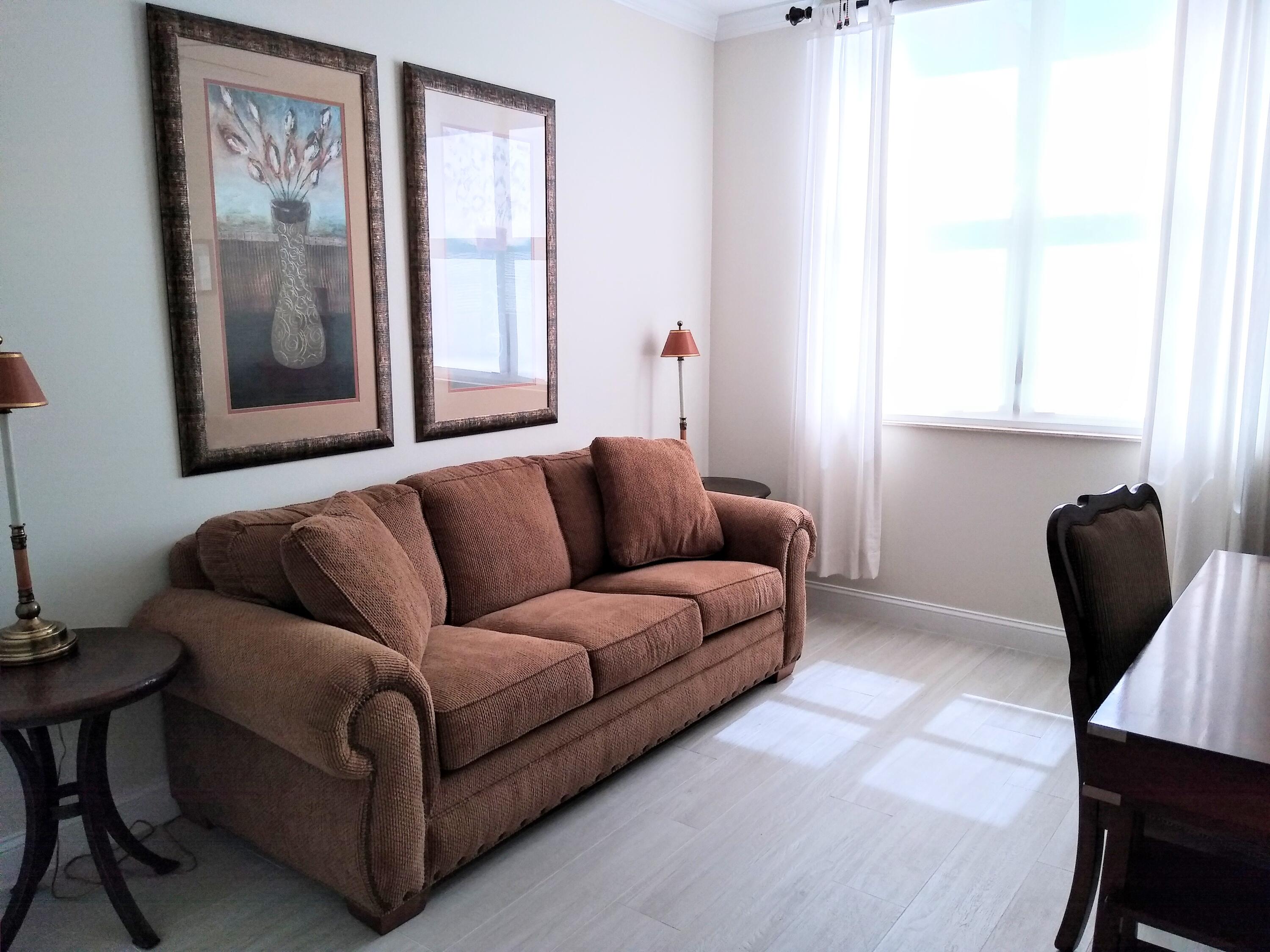 806 East Windward Way, Unit 410 Lantana, FL 33462 - Photo 20 of 33 a living room with furniture and a window