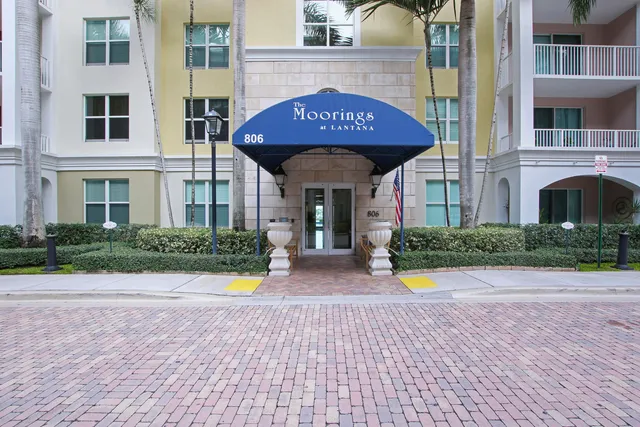 a view of a brick house with potted plants