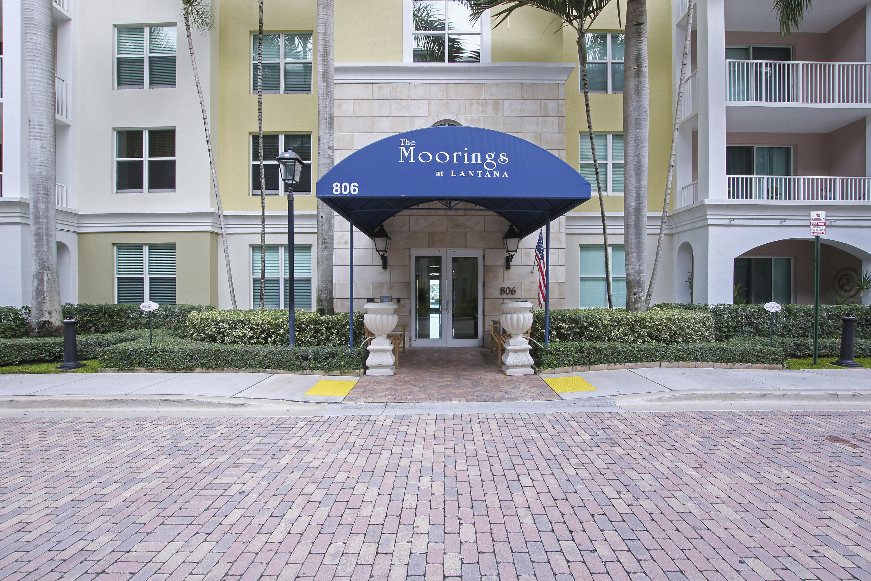 806 East Windward Way, Unit 410 Lantana, FL 33462 - Photo 22 of 33 a view of a brick house with potted plants
