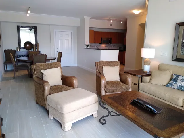 a living room with furniture a flat screen tv and a window