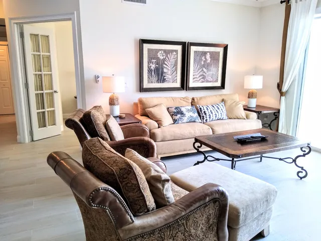 a living room with furniture a rug and a window