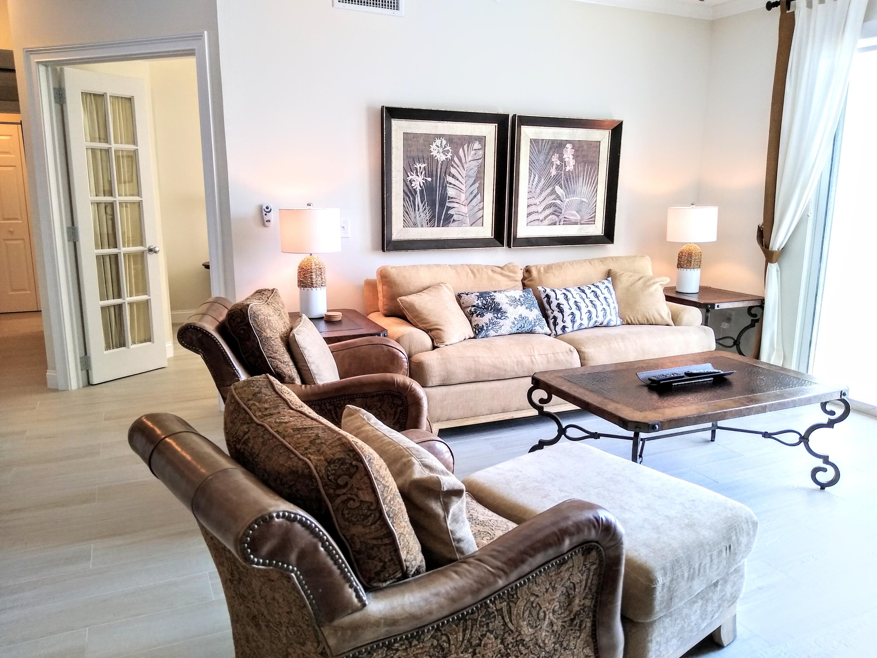 806 East Windward Way, Unit 410 Lantana, FL 33462 - Photo 7 of 33 a living room with furniture a rug and a window