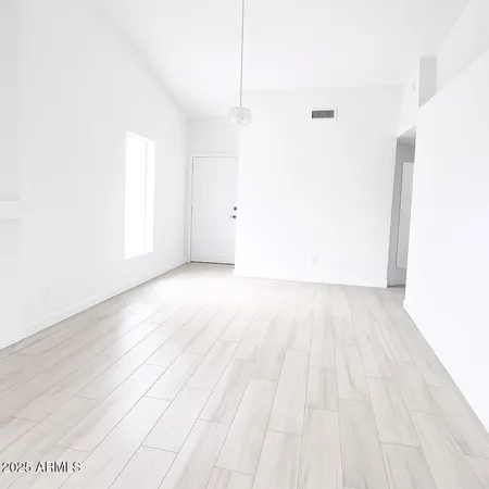 a view of a room with wooden floor