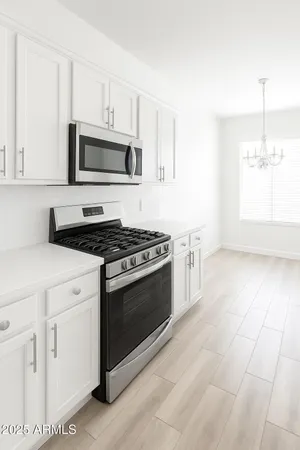 a kitchen with stainless steel appliances white cabinets and a stove