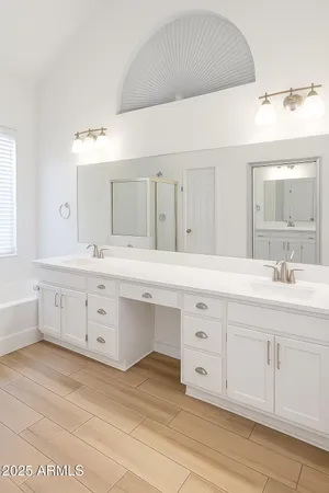 a bathroom with a double vanity sink mirror and