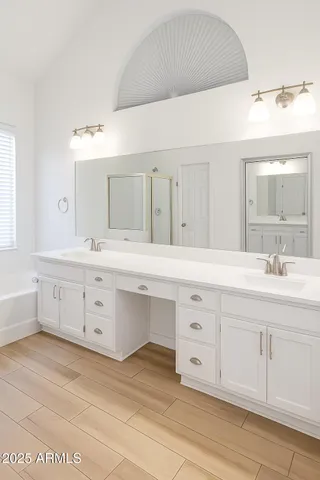 a bathroom with a double vanity sink mirror and