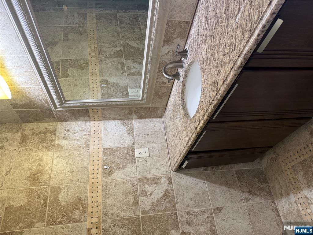 200 Old Palisade Road, Unit 7J Fort Lee, NJ 07024 - Photo 17 of 20 a bathroom with a granite countertop sink and a window