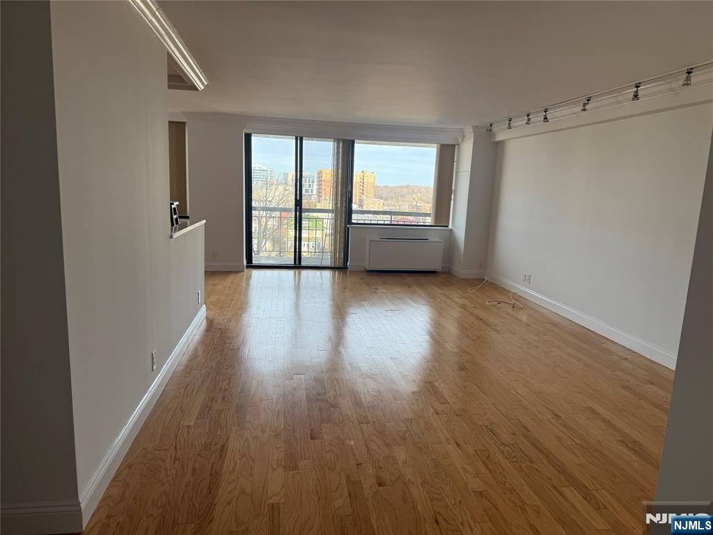 200 Old Palisade Road, Unit 7J Fort Lee, NJ 07024 - Photo 10 of 20 a view of an empty room with a window and wooden floor