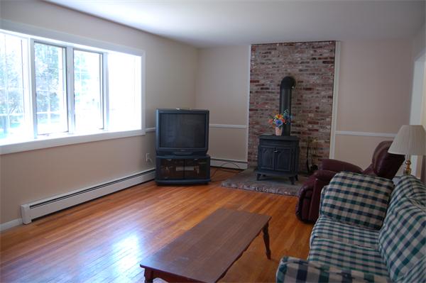 8 Ipswich Road Topsfield, MA 01983 - Photo 4 of 14 a living room with furniture and a flat screen tv