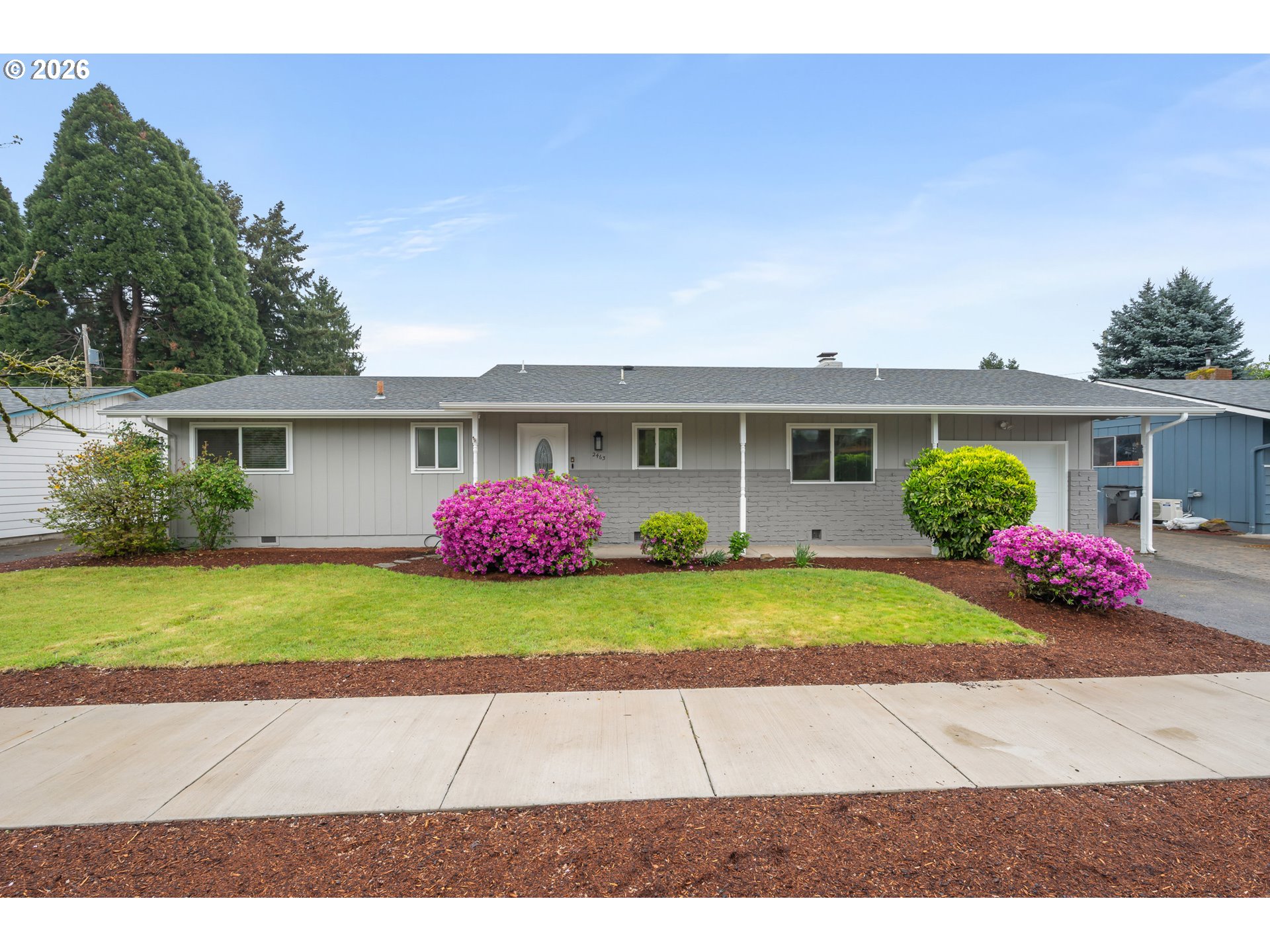 2463 Moore Street Eugene, OR 97404 - Photo 1 of 34 a front view of a house with a yard and a garage