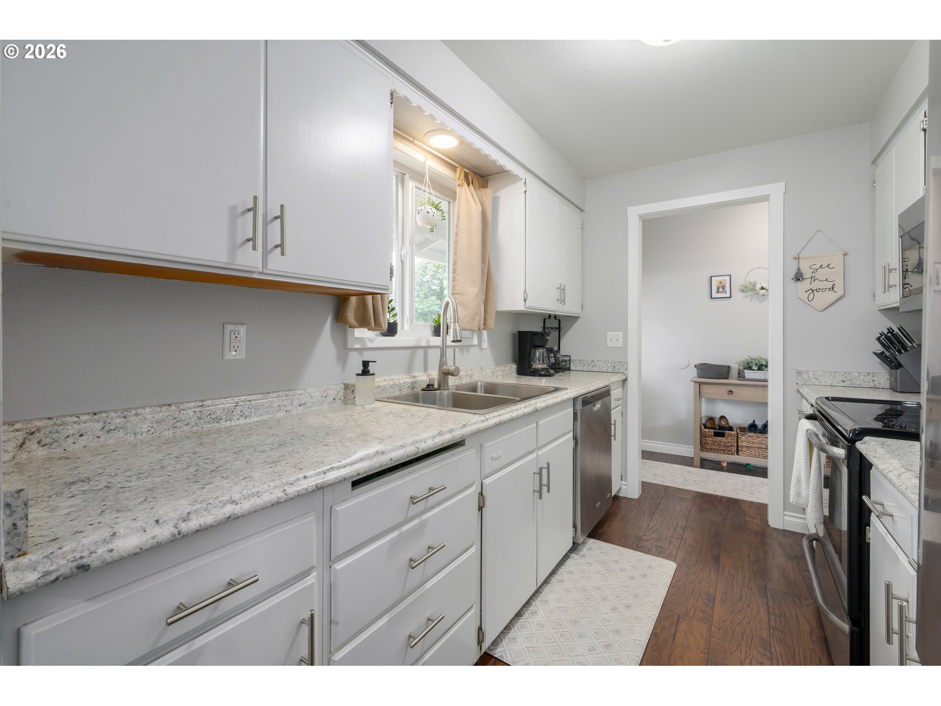 2463 Moore Street Eugene, OR 97404 - Photo 15 of 34 a kitchen with granite countertop a sink cabinets stainless steel appliances and a window