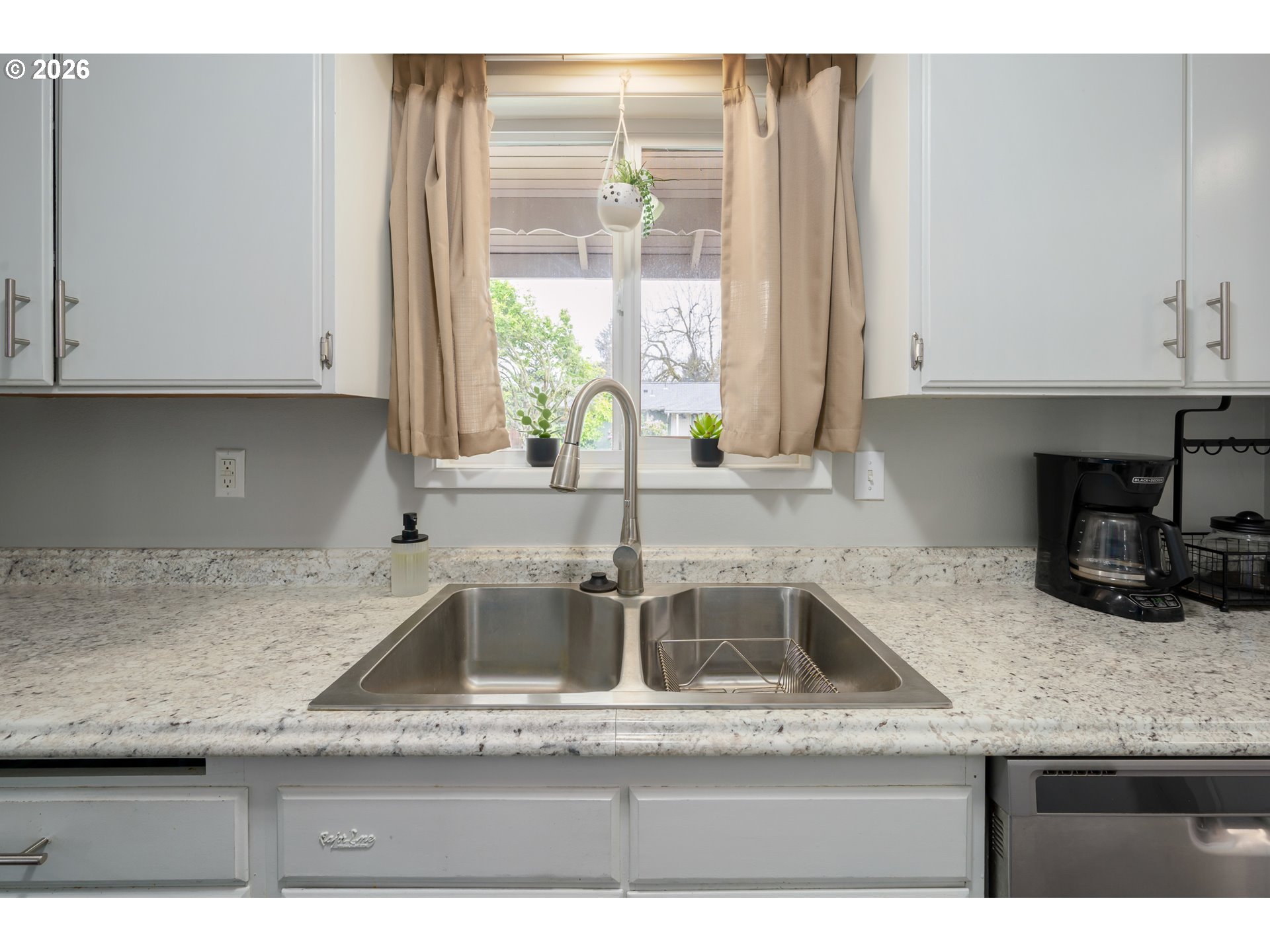 2463 Moore Street Eugene, OR 97404 - Photo 16 of 34 a kitchen with granite countertop a sink and a counter top space