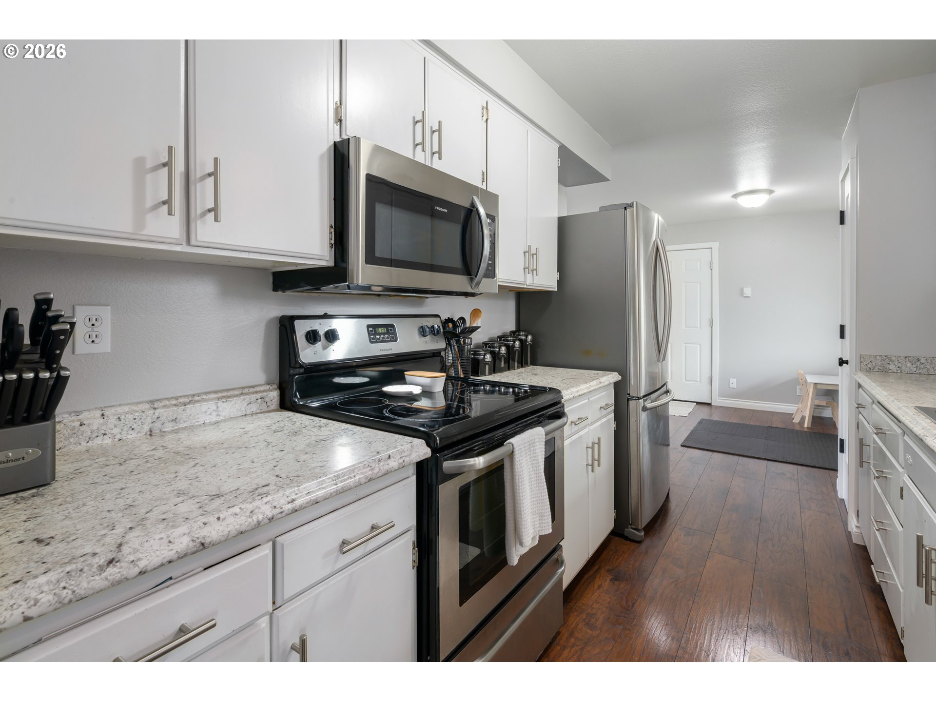 2463 Moore Street Eugene, OR 97404 - Photo 17 of 34 a kitchen with stainless steel appliances granite countertop a stove a sink and a microwave