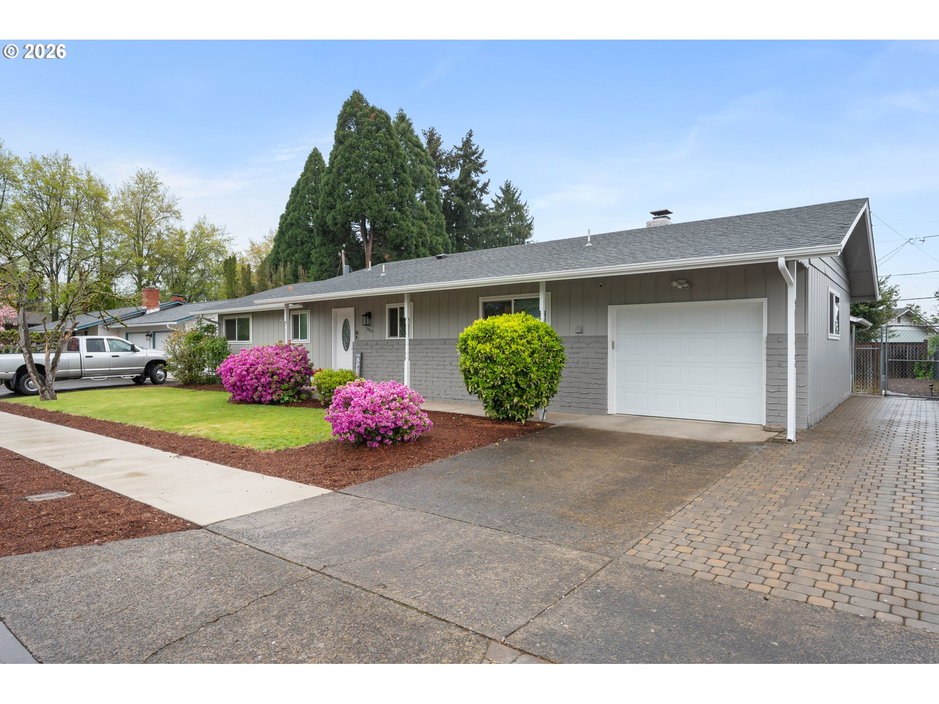 2463 Moore Street Eugene, OR 97404 - Photo 2 of 34 a front view of a house with garden