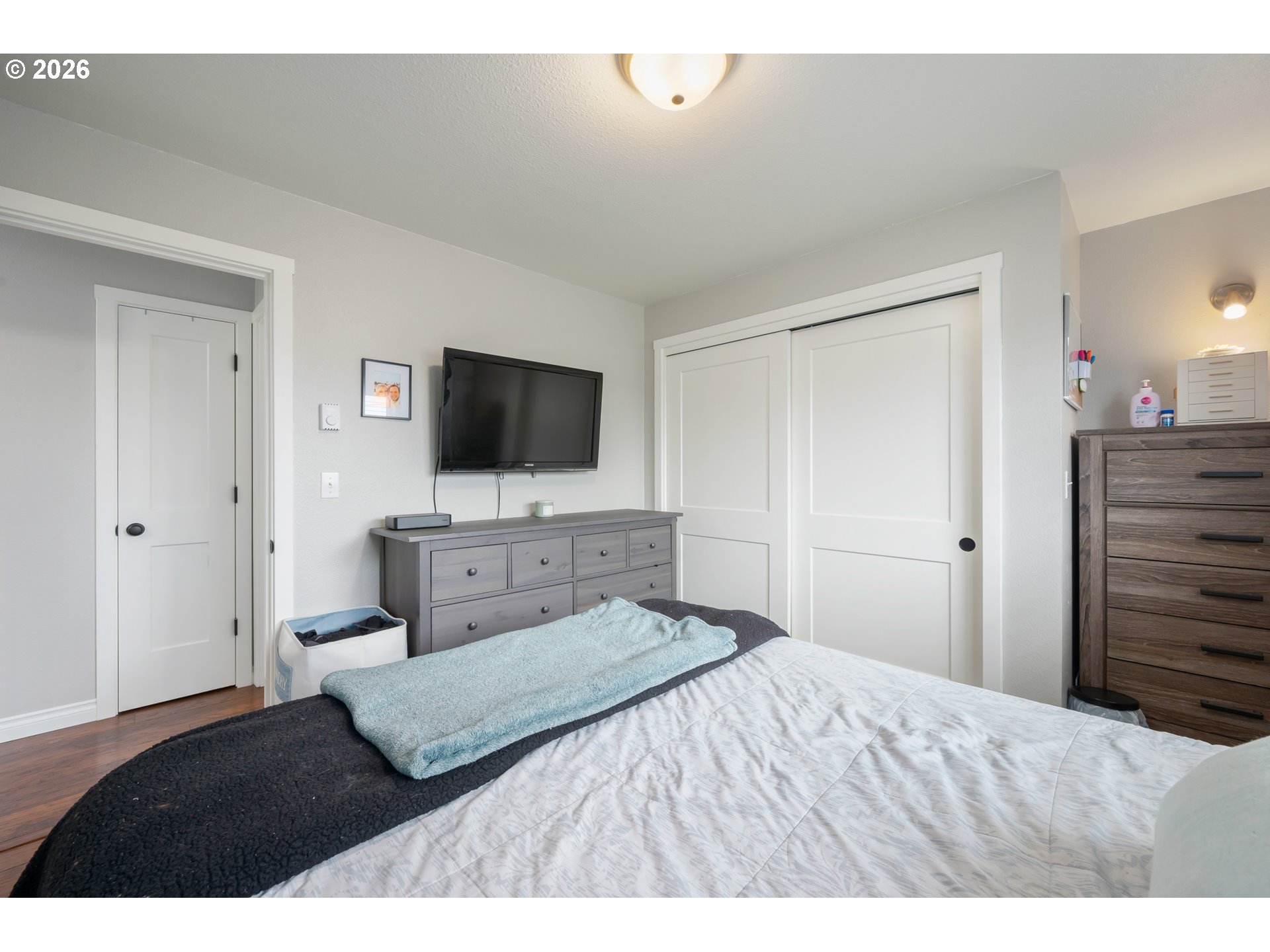 2463 Moore Street Eugene, OR 97404 - Photo 21 of 34 a bedroom with a bed and a flat screen tv