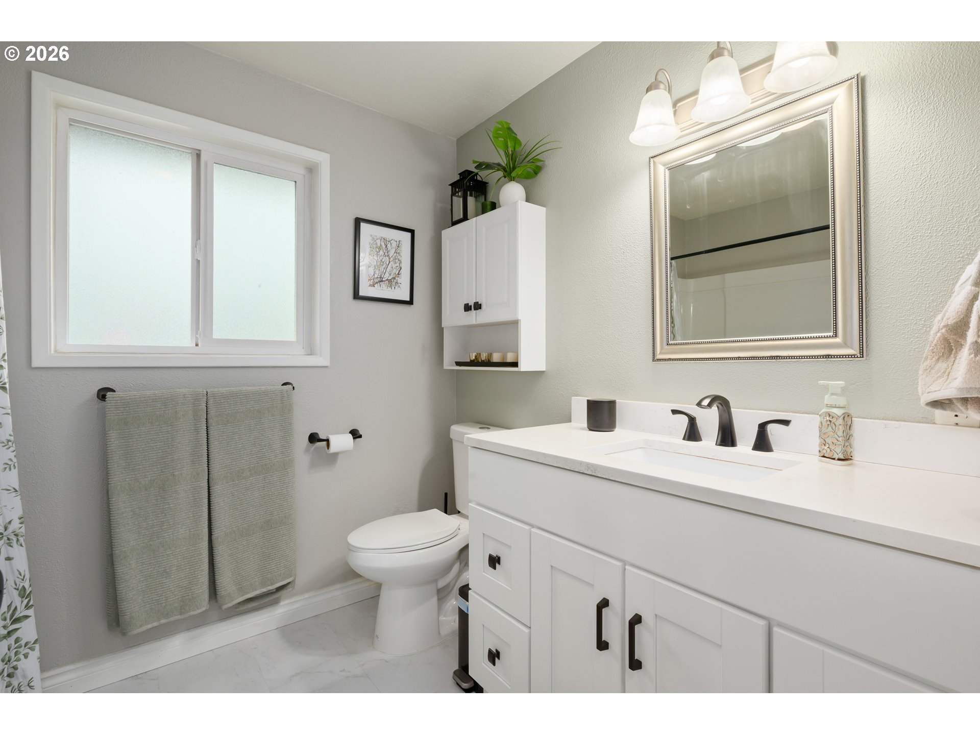 2463 Moore Street Eugene, OR 97404 - Photo 26 of 34 a bathroom with a toilet a sink a vanity and mirror