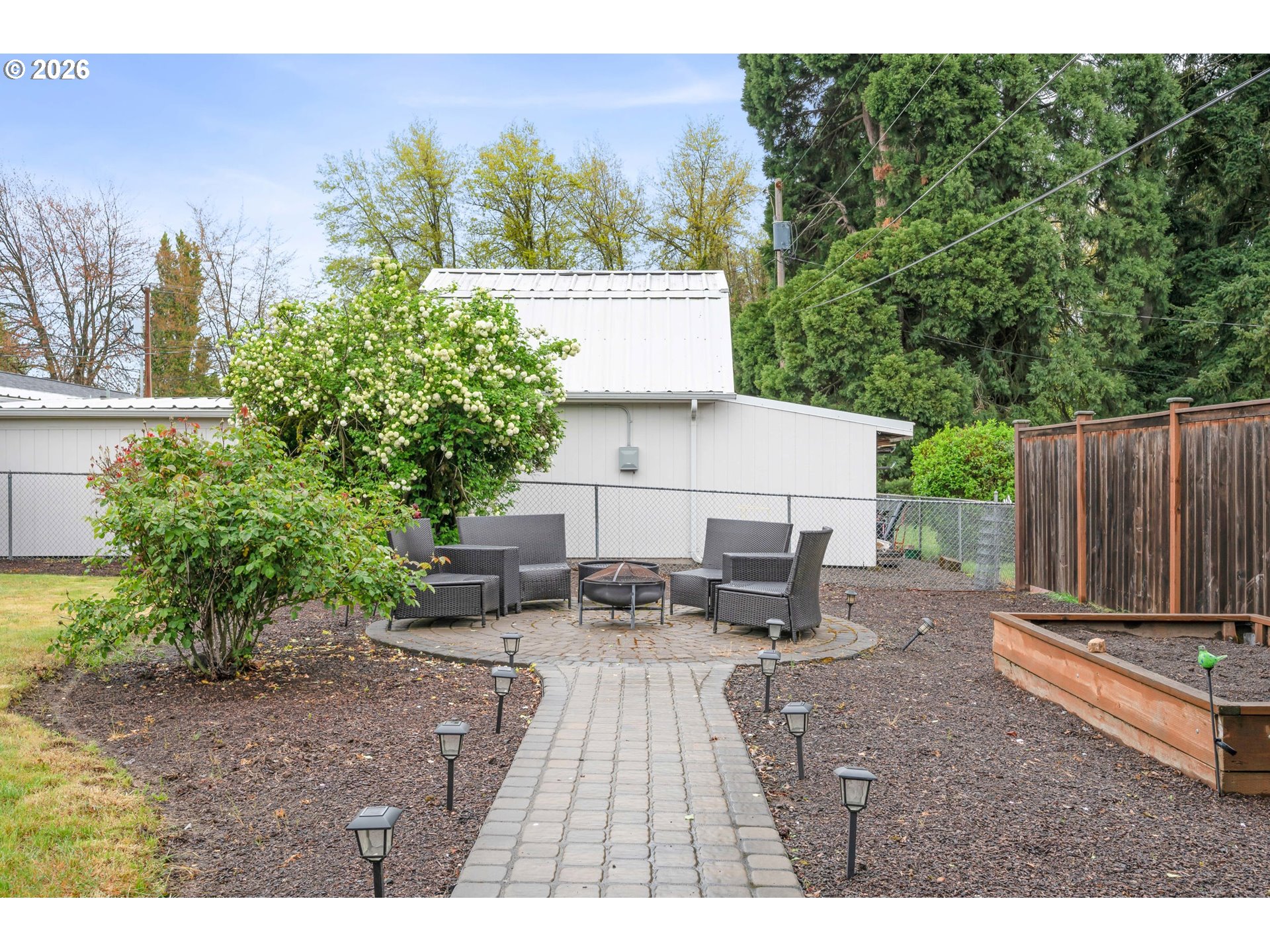 2463 Moore Street Eugene, OR 97404 - Photo 30 of 34 a view of house with backyard outdoor seating and trees