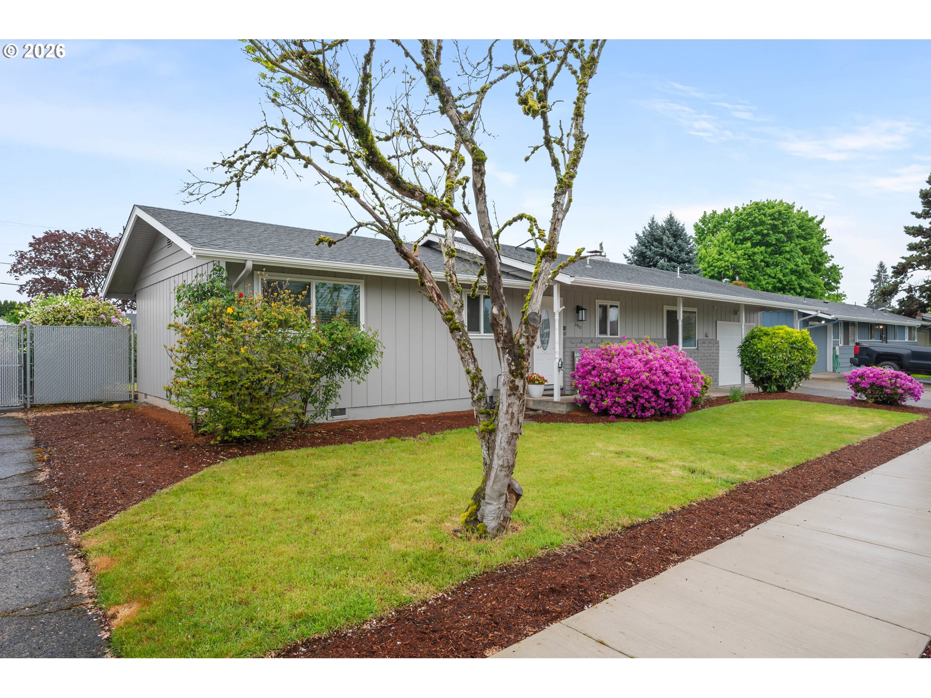 2463 Moore Street Eugene, OR 97404 - Photo 3 of 34 a front view of a house with garden