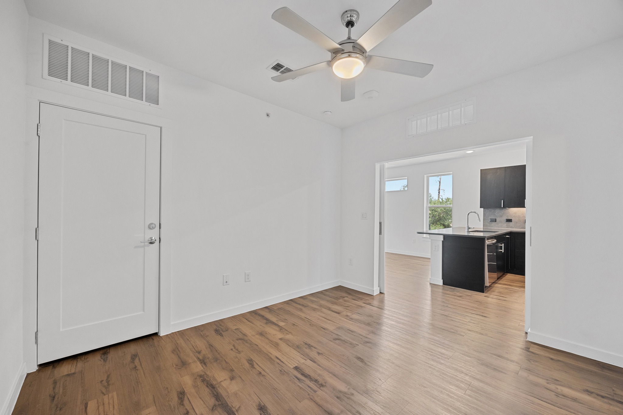 4801 Springdale Road, Unit 2301 Austin, TX 78723 - Photo 18 of 36 Laminate flooring connects this spacious room to the adjoining kitchen, perfect for relaxed living.