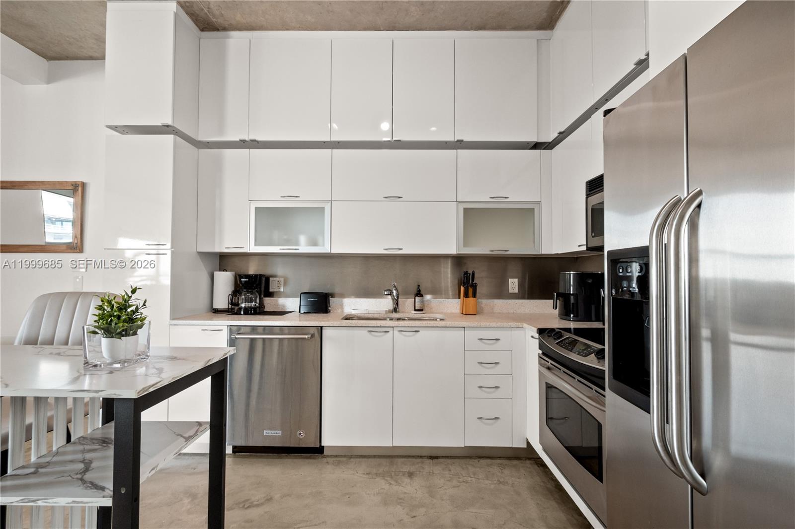 234 Northeast 3rd Street, Unit 1704 Miami, FL 33132 - Photo 11 of 35 a kitchen with stainless steel appliances granite countertop a refrigerator a stove and a sink