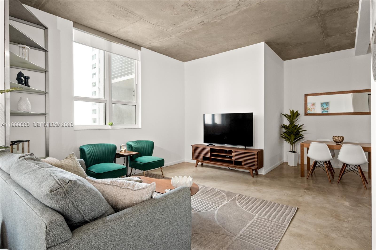 234 Northeast 3rd Street, Unit 1704 Miami, FL 33132 - Photo 24 of 35 a living room with furniture and a flat screen tv
