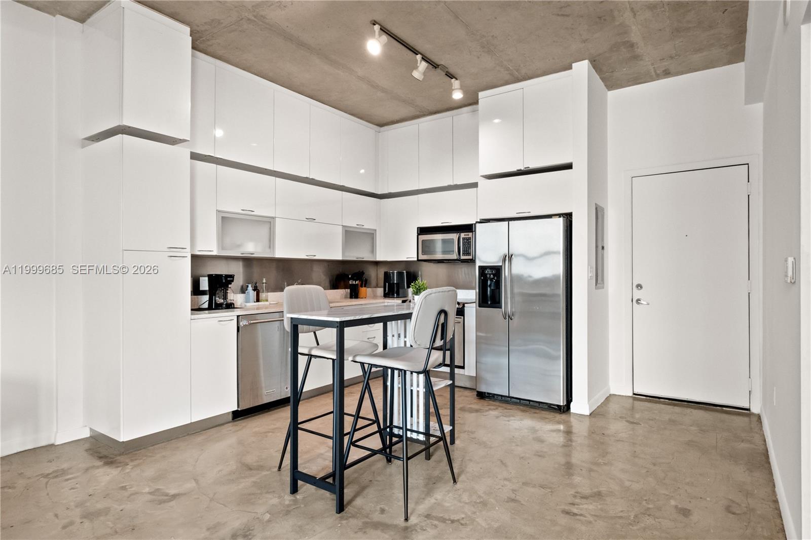 234 Northeast 3rd Street, Unit 1704 Miami, FL 33132 - Photo 3 of 35 a kitchen with stainless steel appliances a refrigerator and microwave