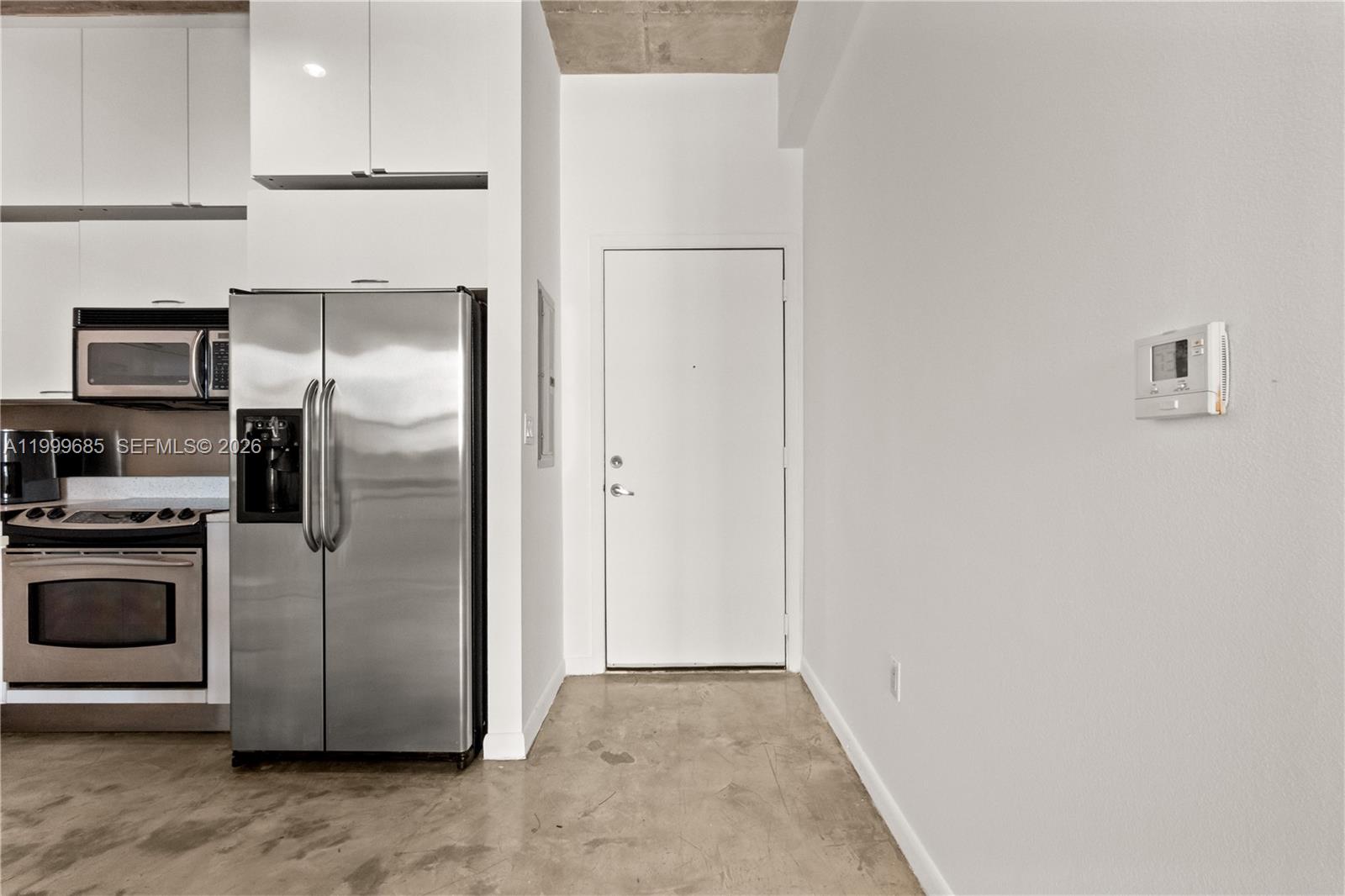 234 Northeast 3rd Street, Unit 1704 Miami, FL 33132 - Photo 10 of 35 a kitchen with a refrigerator and a stove